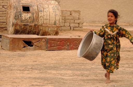 iraqi girl runs to water truck